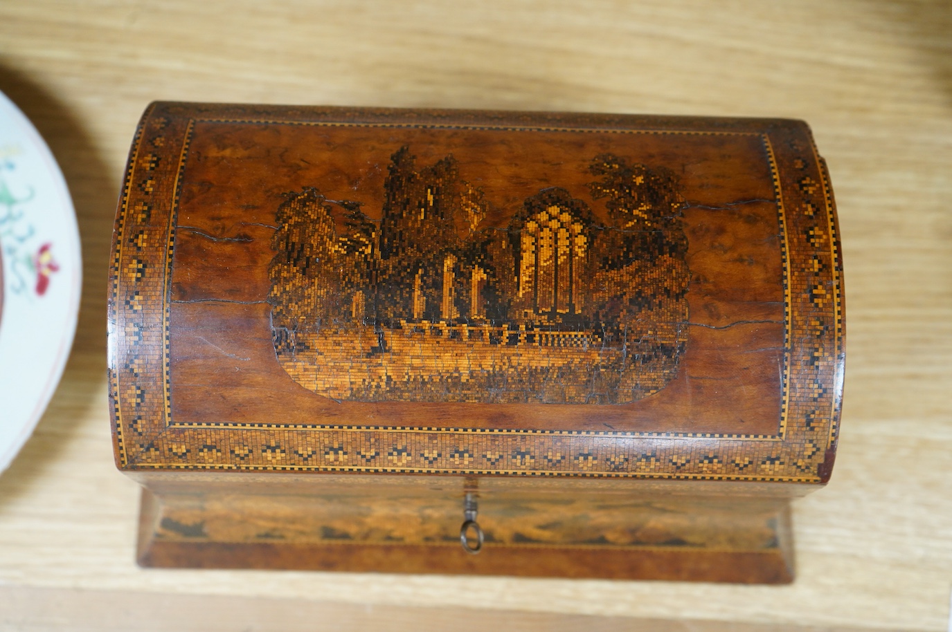 A Tunbridgeware box of domed form, with a scene of an Abbey ruins, 25cm wide